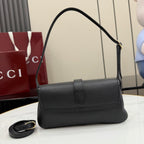 Black Gucci small shoulder bag with top handle and flap front, side profile