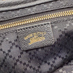 Gucci interior label on zipper pocket, black jacquard lining, close-up detail