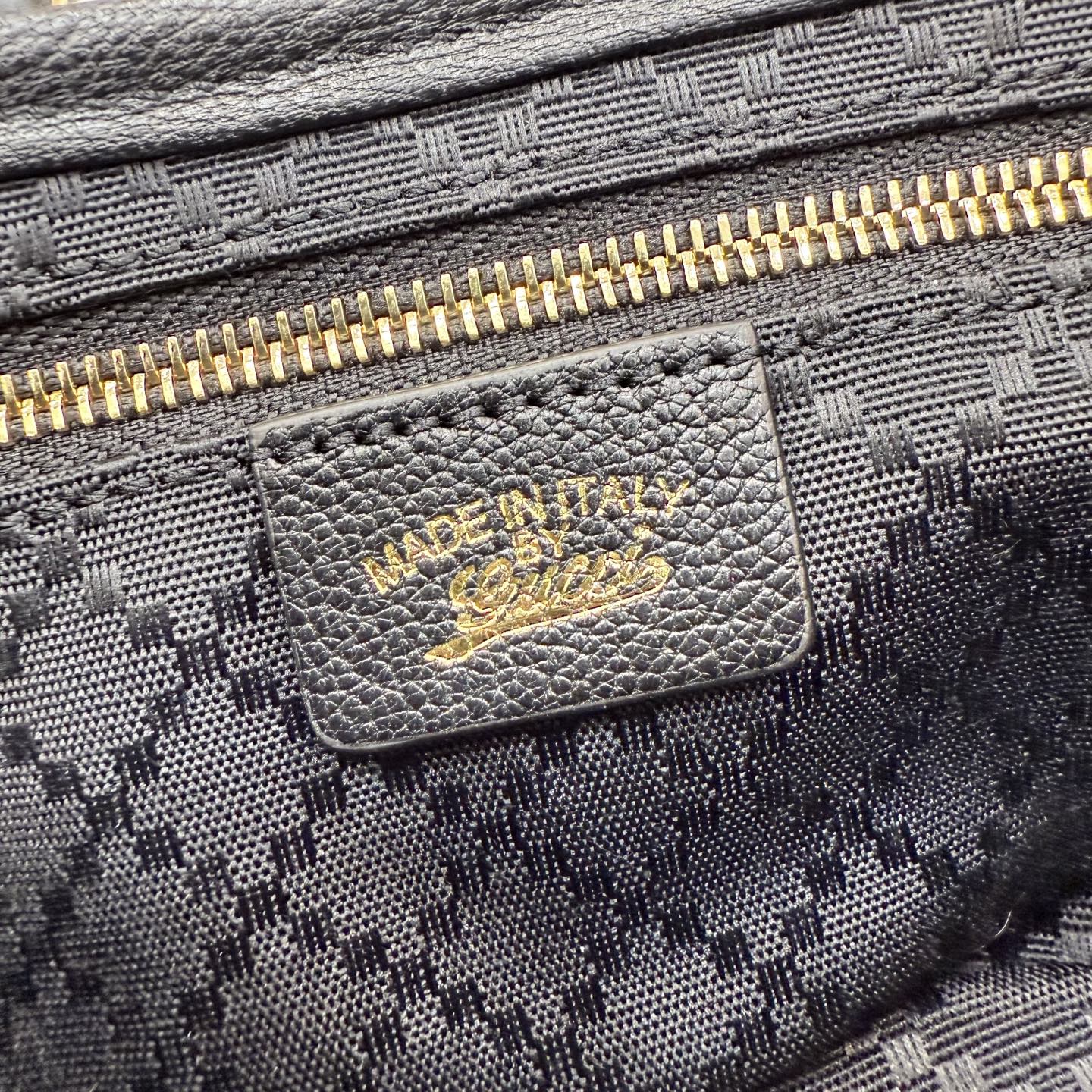 Gucci interior label on zipper pocket, black jacquard lining, close-up detail