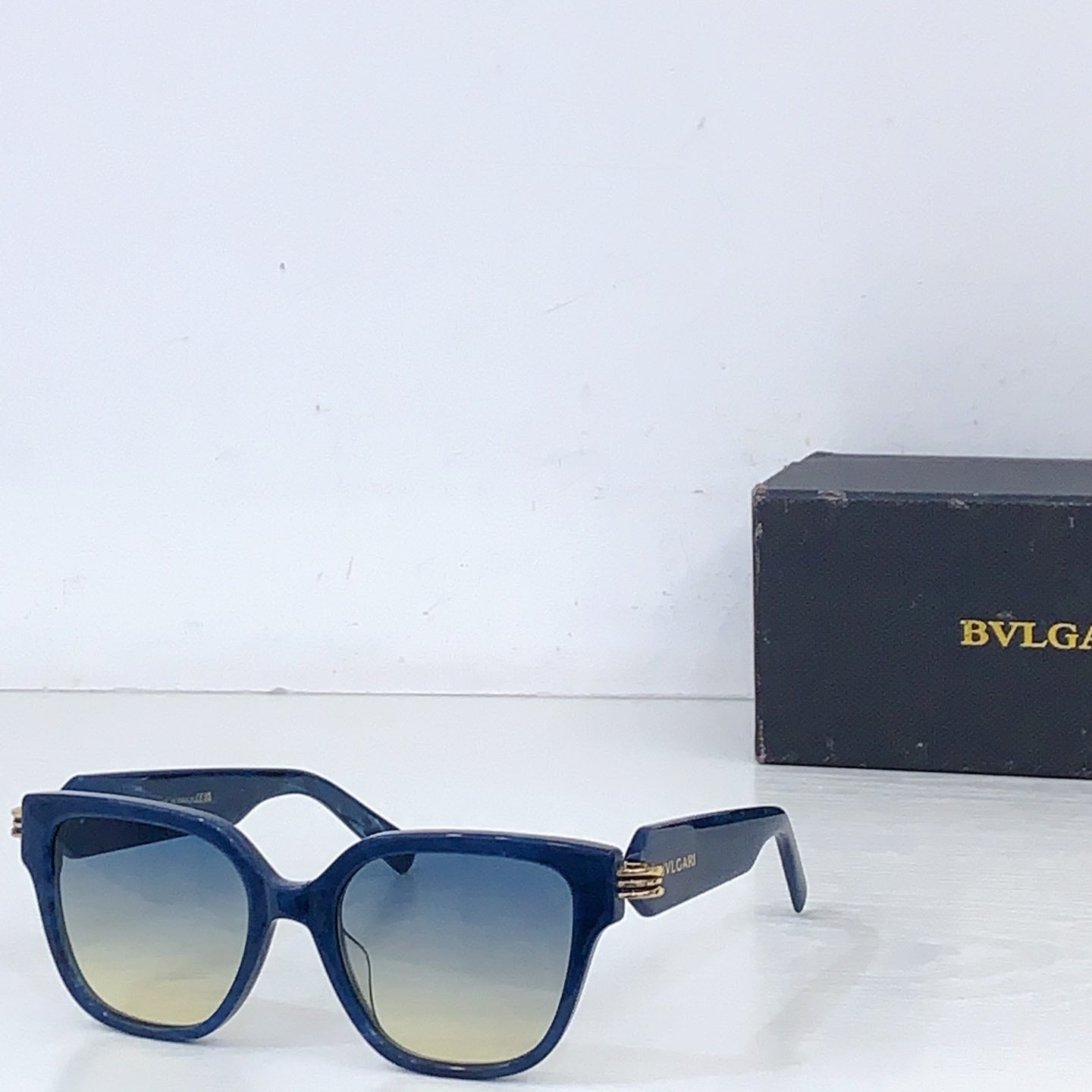 Bvlgari square sunglasses with blue frame and light tan tinted lenses
