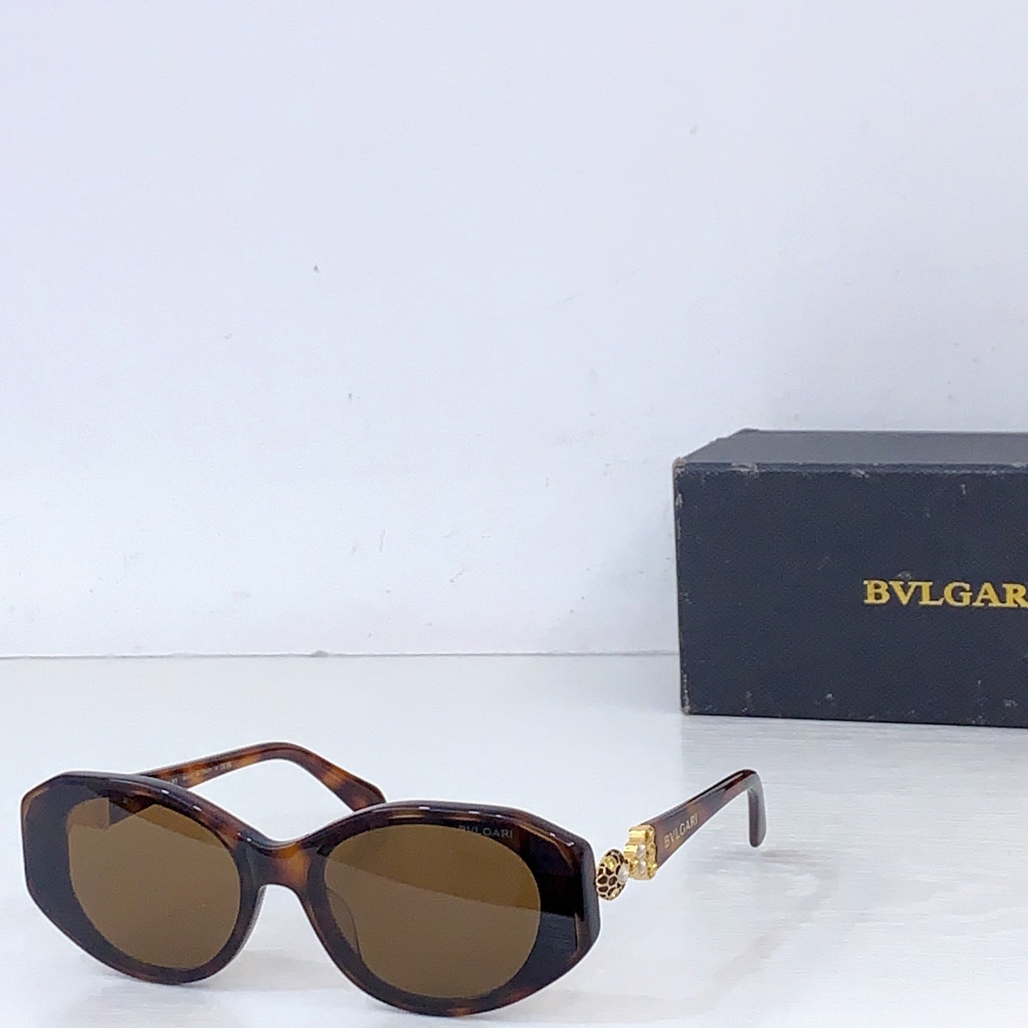 Bvlgari tortoiseshell sunglasses with brown lenses and metal hinge detail