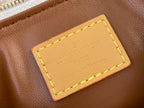 Brown leather luggage tag with yellow-stitched frame and Louis Vuitton logo