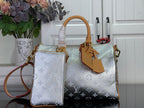 Monogram canvas tote bag with light silver finish and tan leather handles