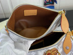 Silver monogram canvas bag interior with tan base and gold zipper closure