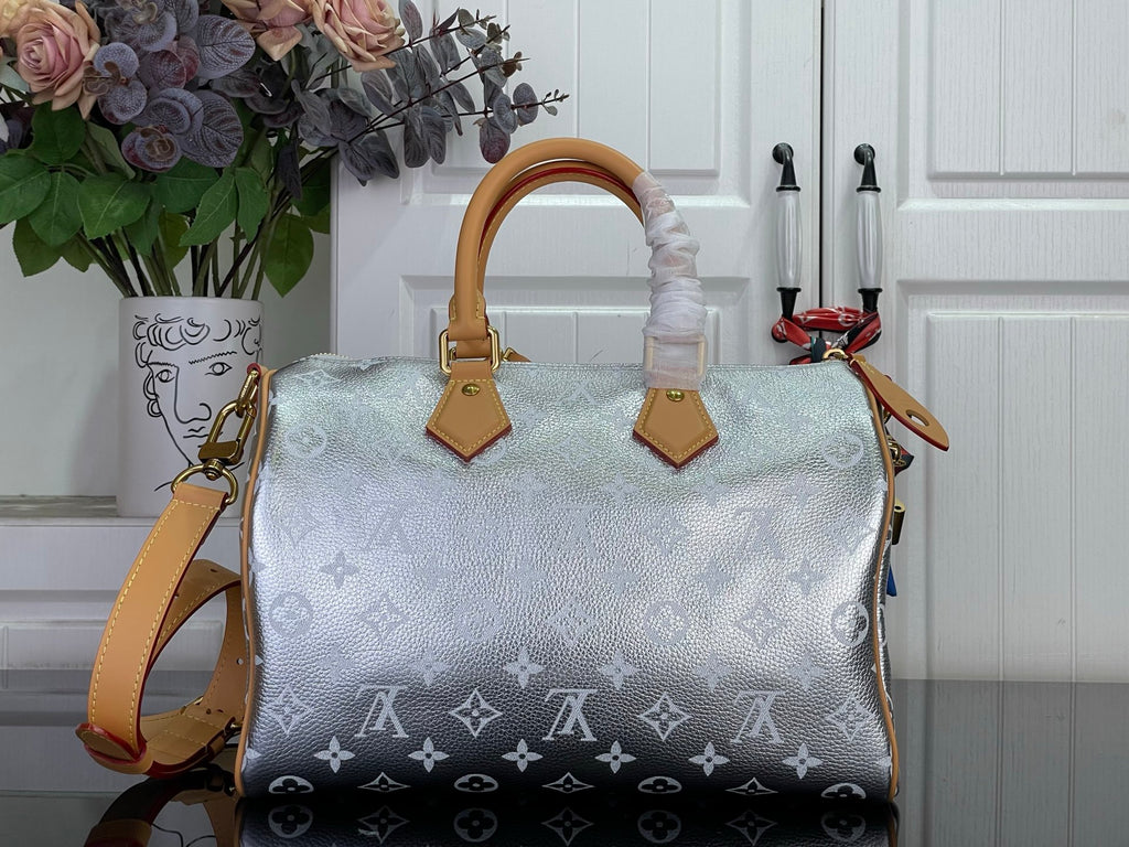 Monogram canvas satchel with light silver body, tan handles, and crossbody strap