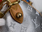 Silver monogram canvas hobo bag with tan leather triangle patch and gold ring