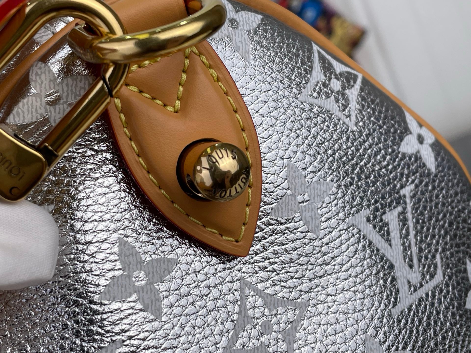 Silver monogram canvas hobo bag with tan leather triangle patch and gold ring