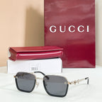Square sunglasses with dark lenses, black frame, and gold metal accents