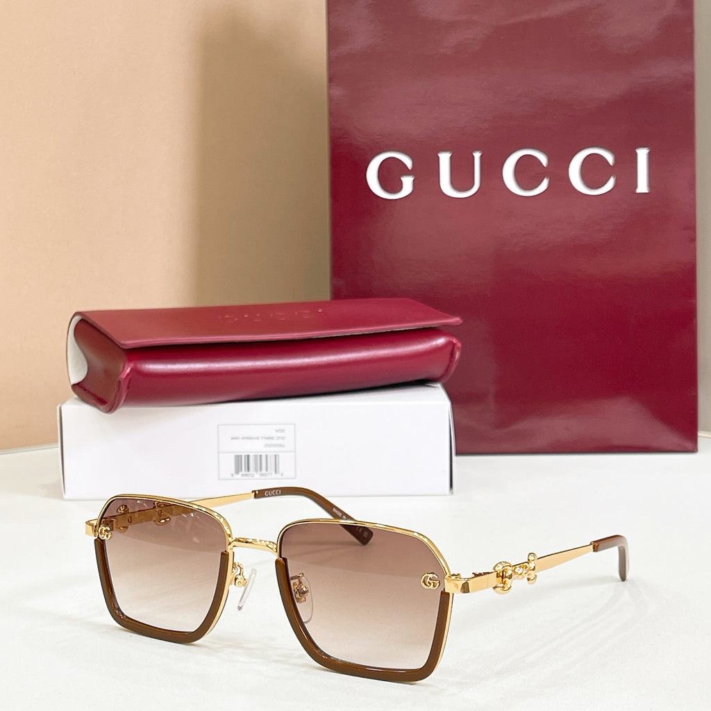 Square sunglasses with brown gradient lenses, gold frame, and gold metal accents