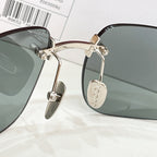 Sunglasses close-up with gold metal temples and gray-green lenses