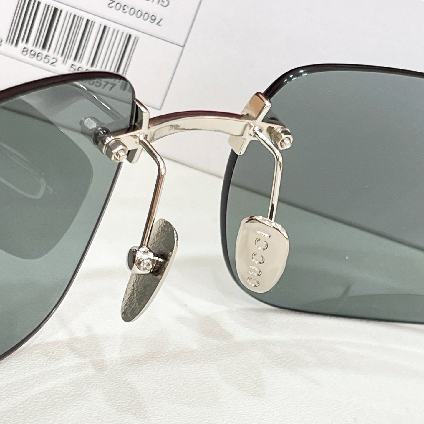 Sunglasses close-up with gold metal temples and gray-green lenses