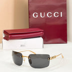 Sunglasses with gold frame and dark charcoal gradient lenses