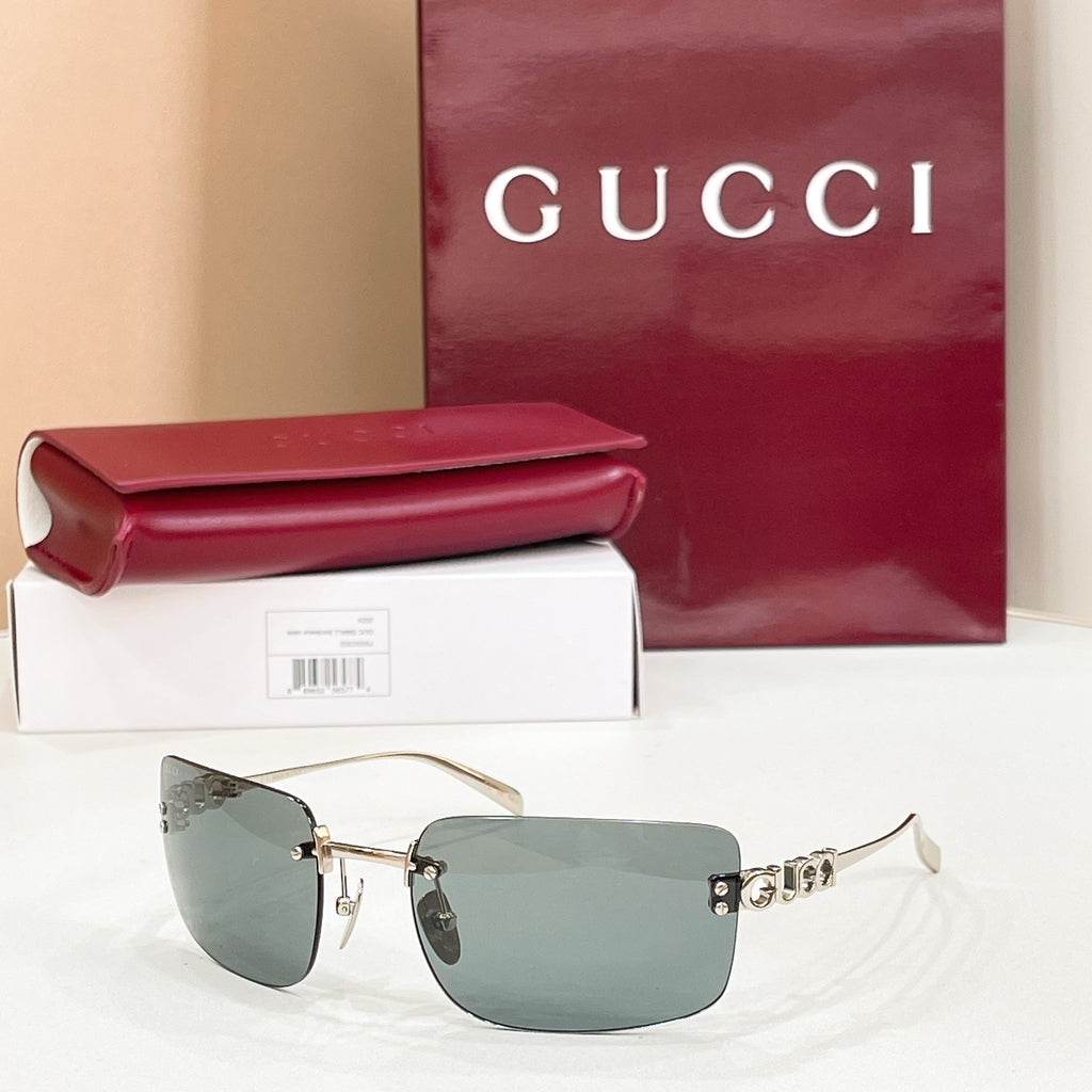 Sunglasses with gold frame and muted green gradient lenses