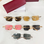 Set of sunglasses with gold frames and brown, pink, and black lenses