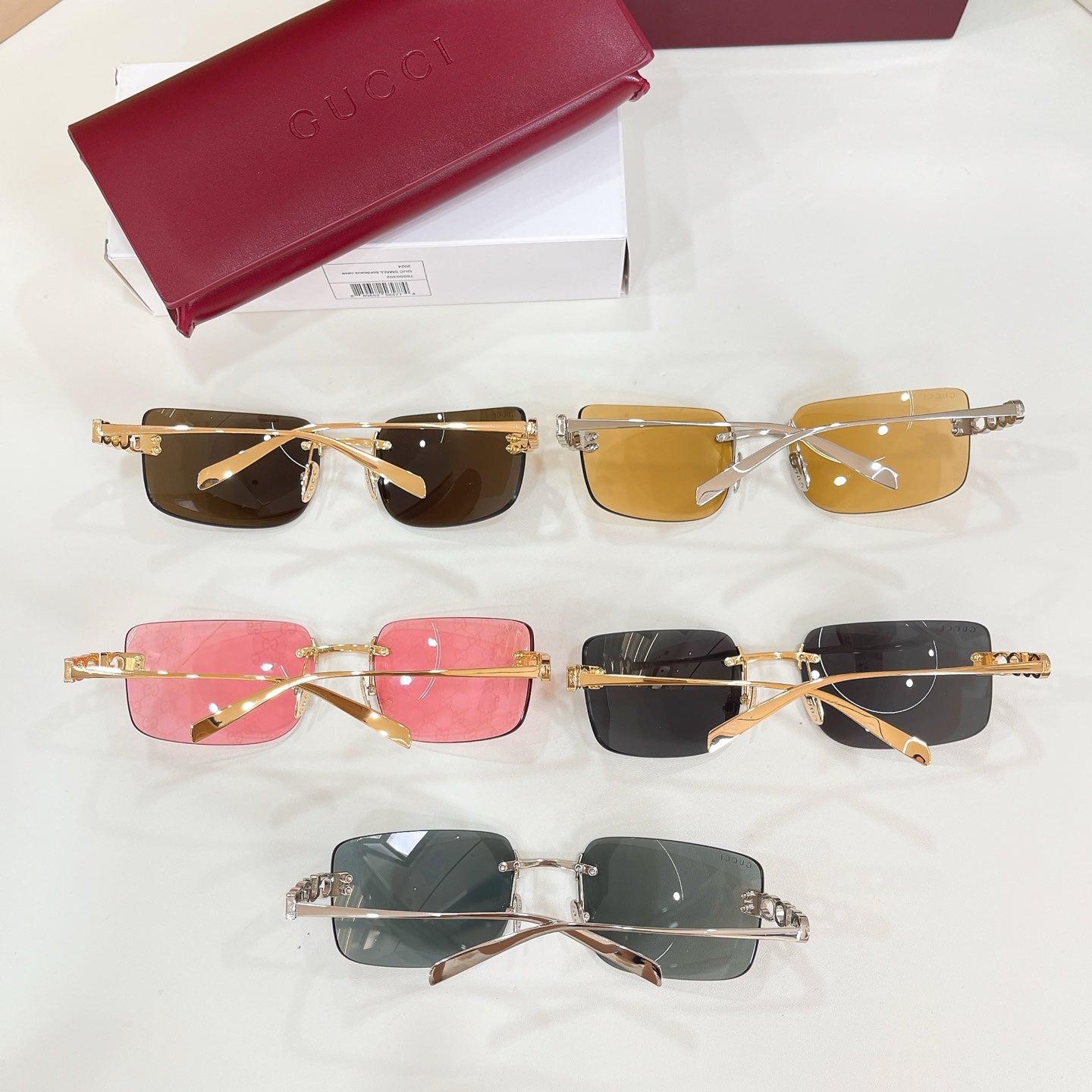 Set of sunglasses with gold frames and brown, pink, and black lenses