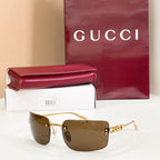 Sunglasses with gold frame and dark brown gradient lenses