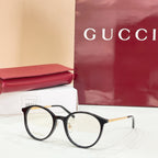 Gucci eyeglasses with round black frames and clear lenses