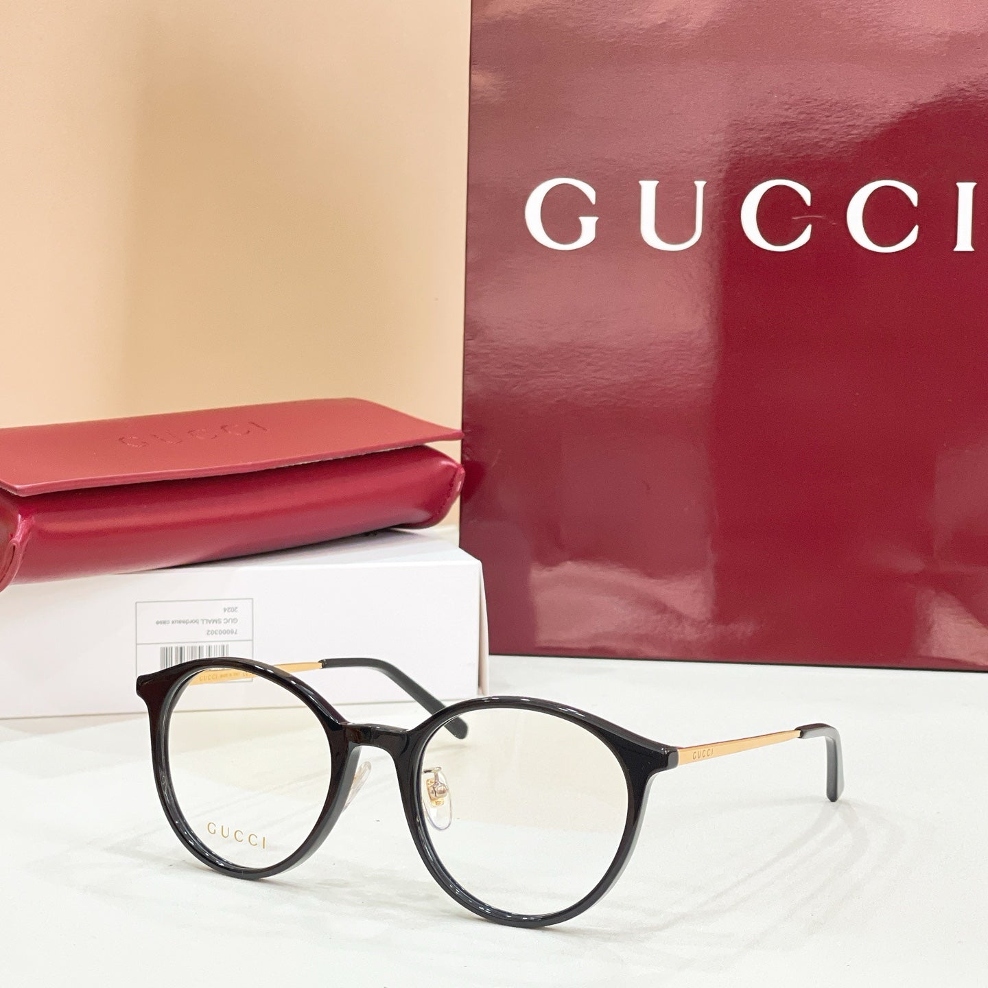 Gucci eyeglasses with round black frames and clear lenses
