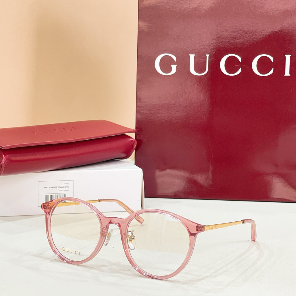 Gucci eyeglasses with round pink frames and clear lenses