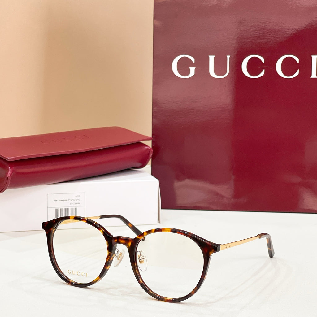 Gucci eyeglasses with round dark tortoiseshell frames and clear lenses