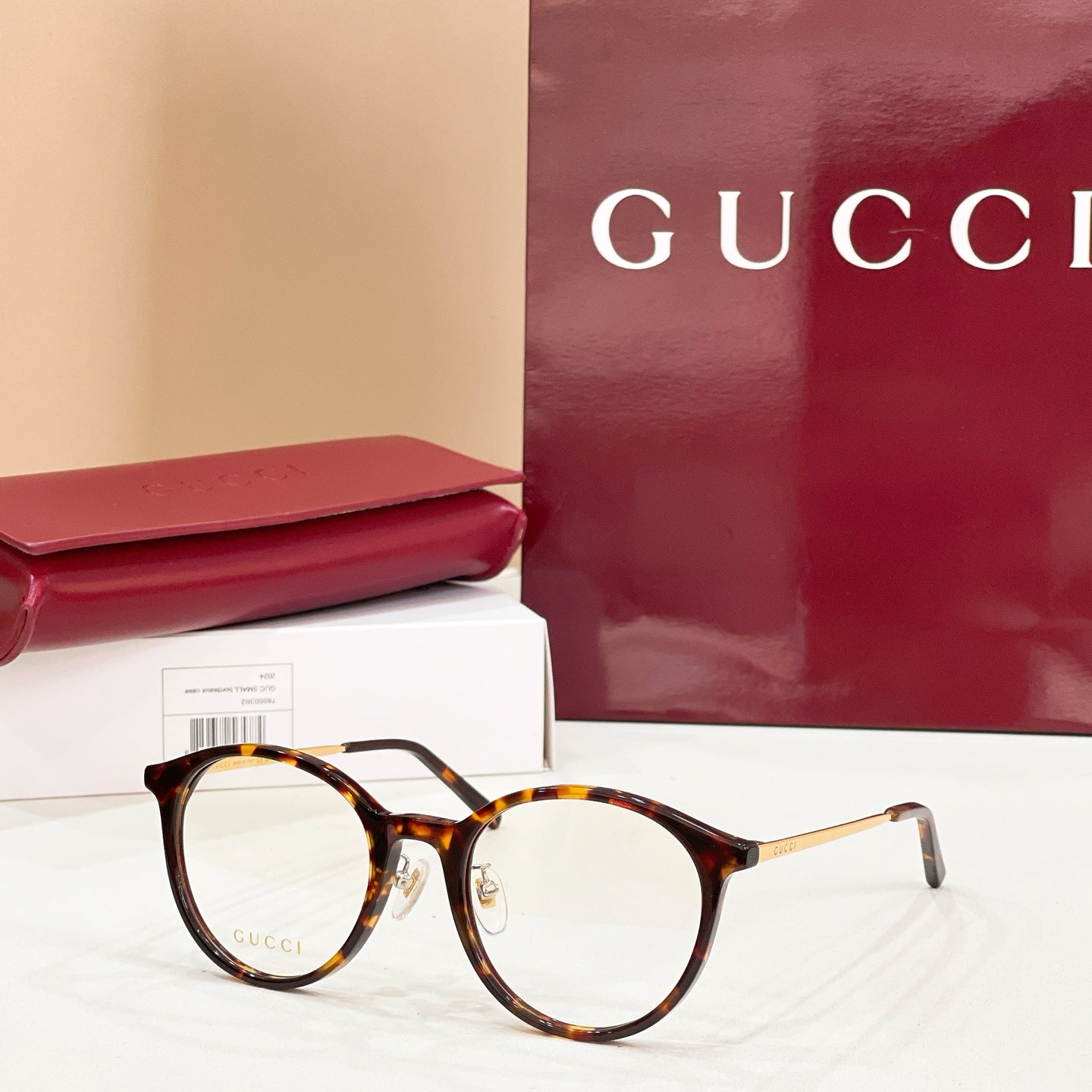 Gucci eyeglasses with round dark tortoiseshell frames and clear lenses