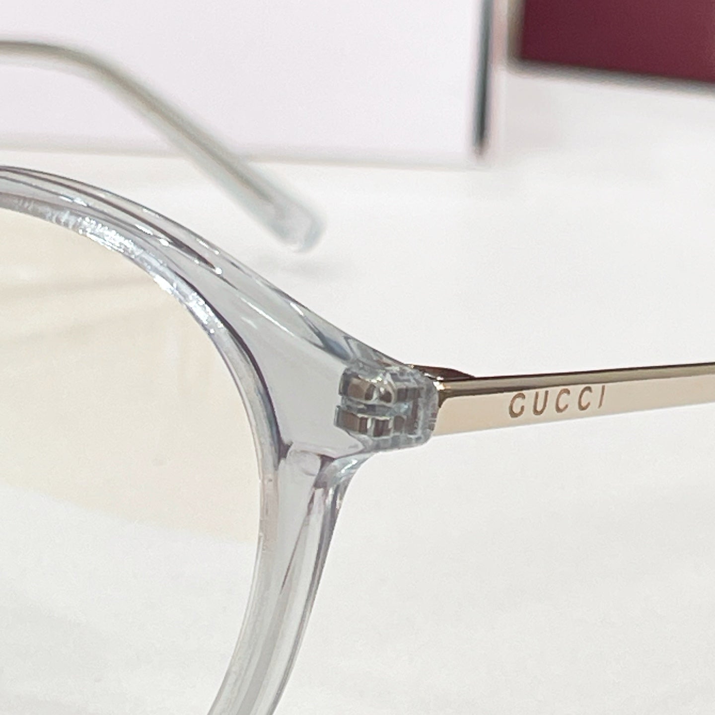 Gucci eyeglasses close-up of clear temple arm with CUCCI branding