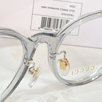 Gucci eyeglasses close-up of clear frame bridge and gold logo detail