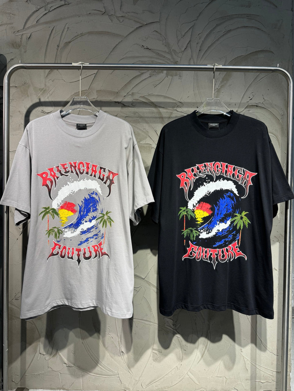 Graphic short-sleeve T-shirts, one light gray and one black, with colorful artwork front