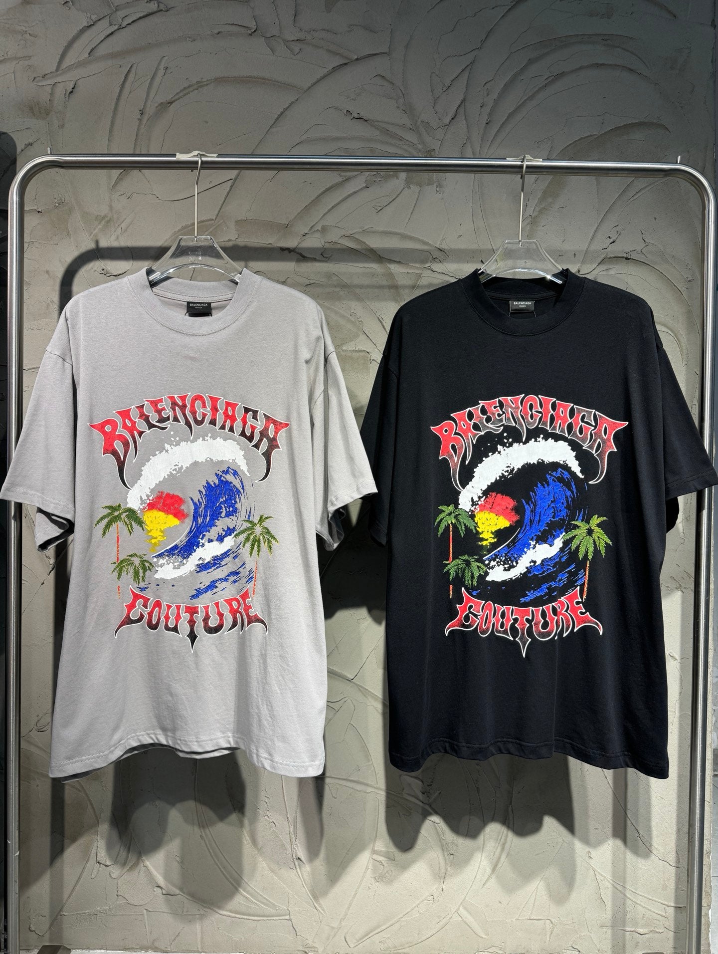 Graphic short-sleeve T-shirts, one light gray and one black, with colorful artwork front