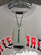 Light gray crewneck T-shirt with hanging Balenciaga tag at the neckline