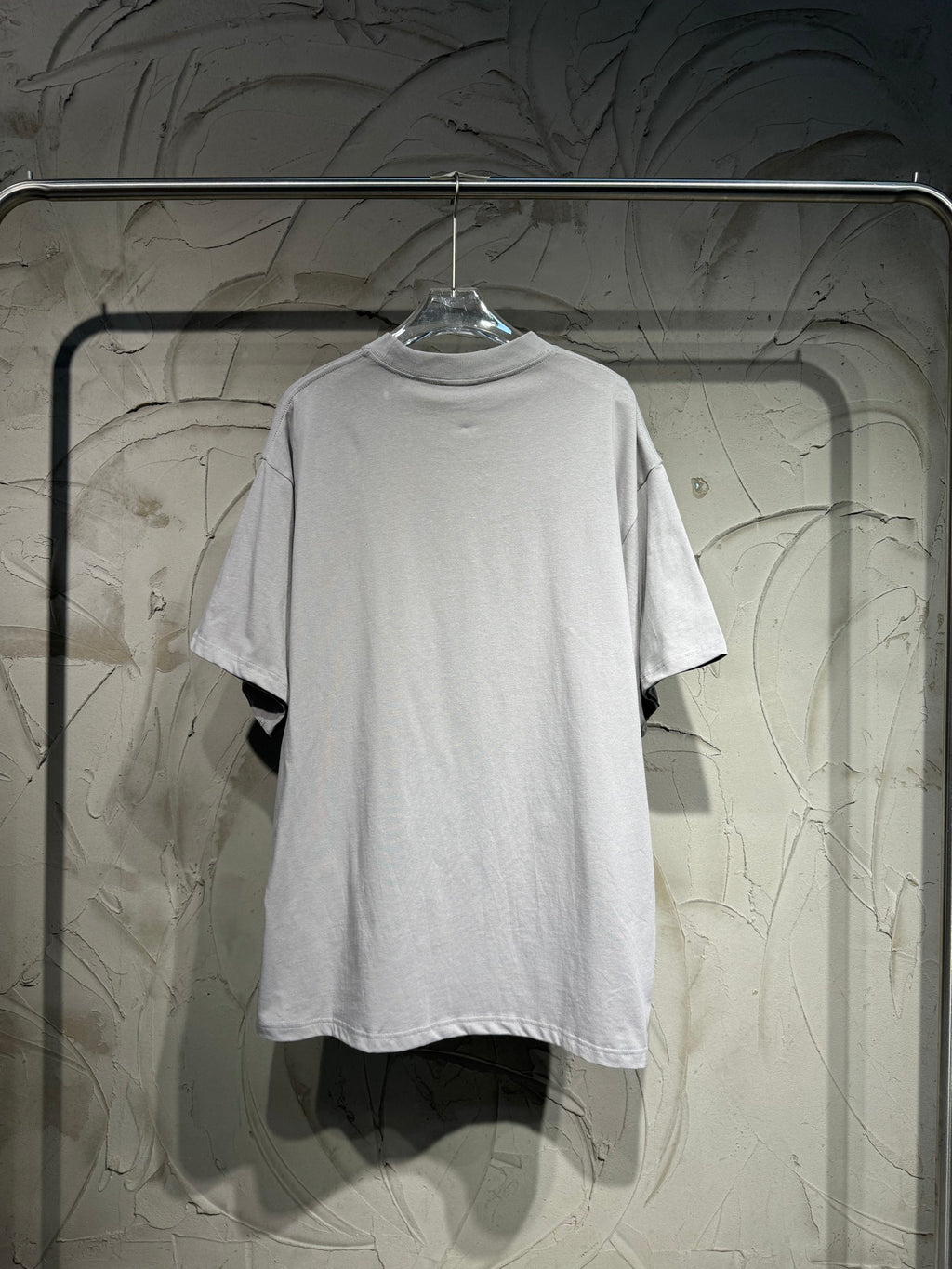 Light gray short-sleeve T-shirt back view with plain crew neckline