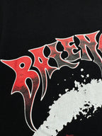 Black T-shirt close-up with red-and-white stylized lettering and paint texture