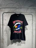 Black graphic T-shirt with colorful globe, palm trees, and stylized lettering on front