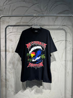 Black graphic T-shirt with colorful globe, palm trees, and stylized lettering on front