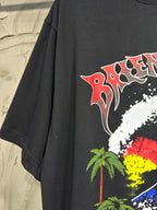 Charcoal T-shirt with large red-and-white graphic swirl and palm accents