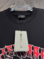 Black T-shirt on hanger with visible collar and hanging retail tag