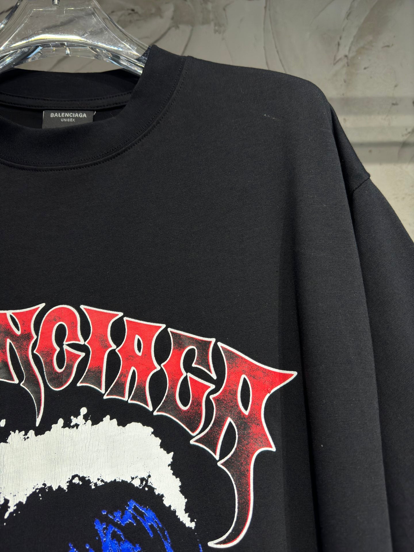 Charcoal graphic T-shirt with red-edged lettering and white paint splash