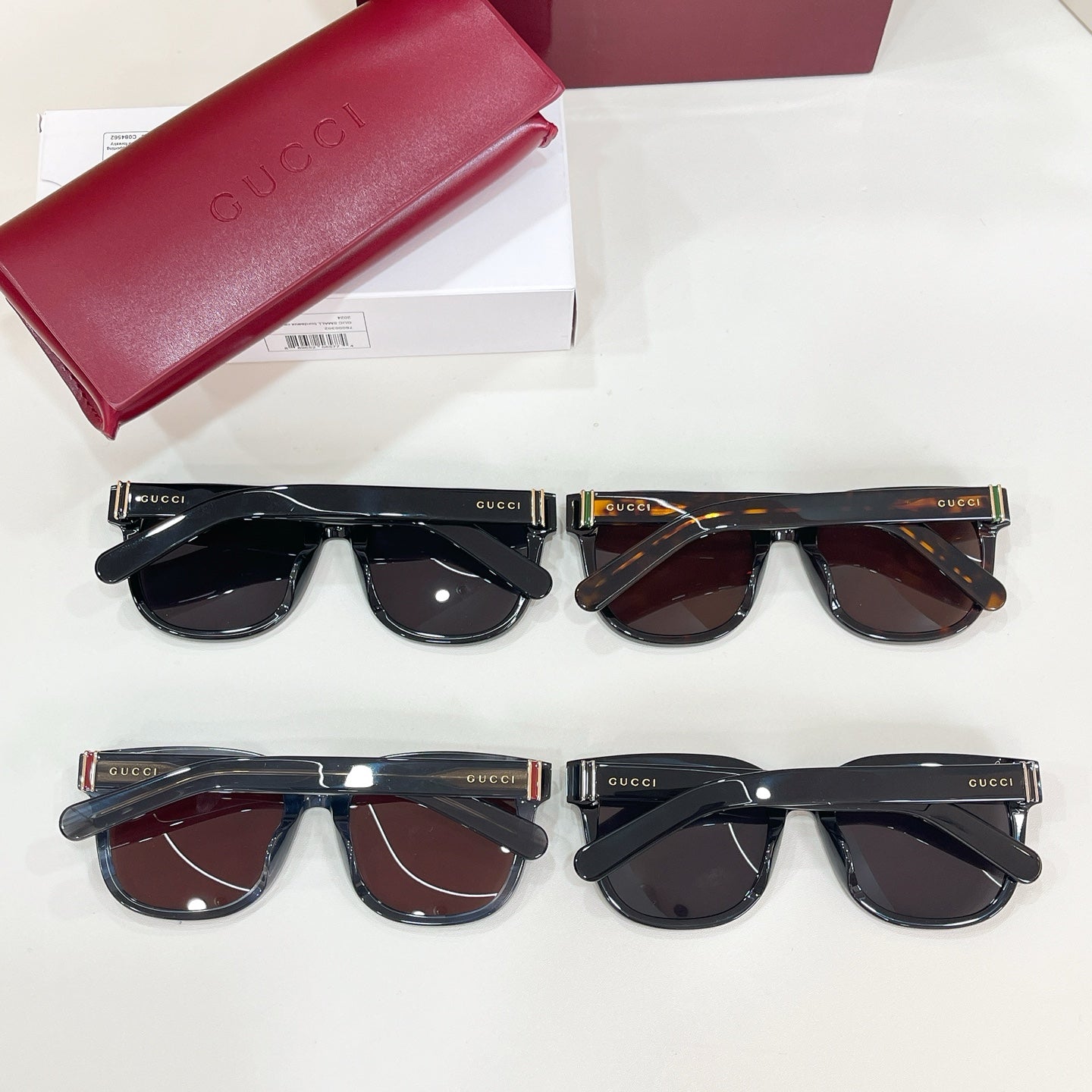 Gucci sunglasses assortment with red case and four pairs of frames