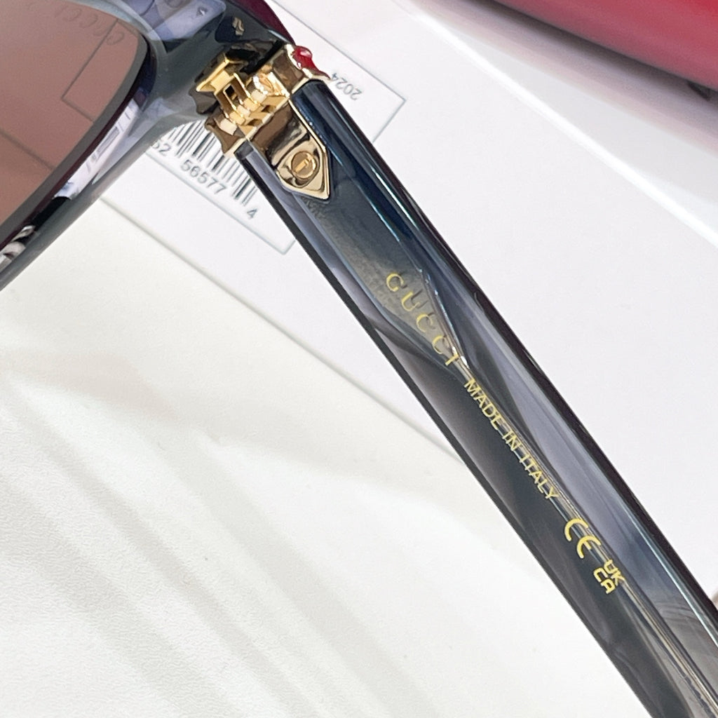 Gucci sunglasses temple detail with gold clasp and lettering