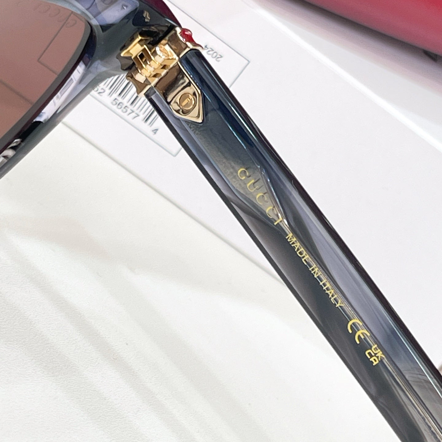 Gucci sunglasses temple detail with gold clasp and lettering
