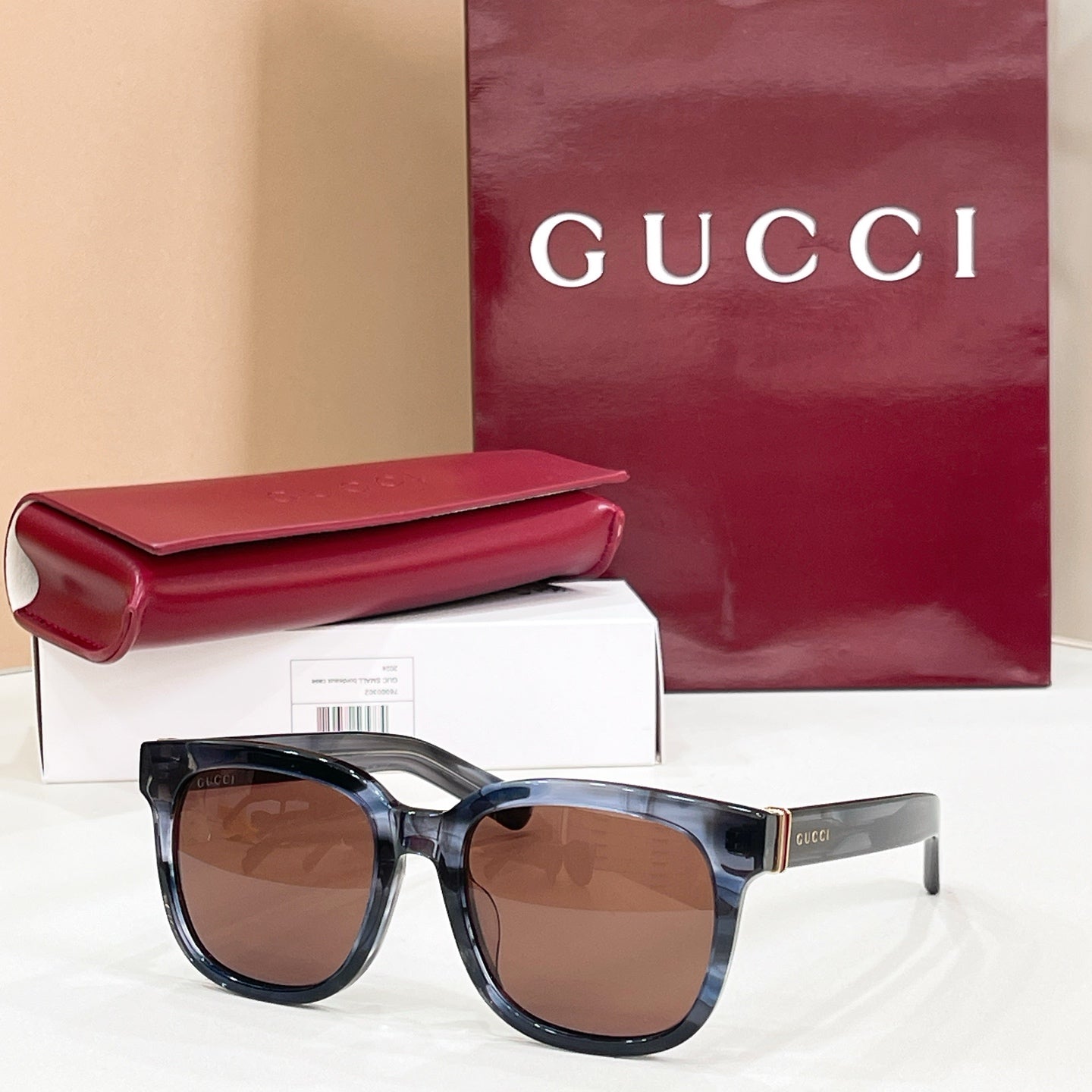 Gucci square sunglasses with blue-black frames and brown lenses