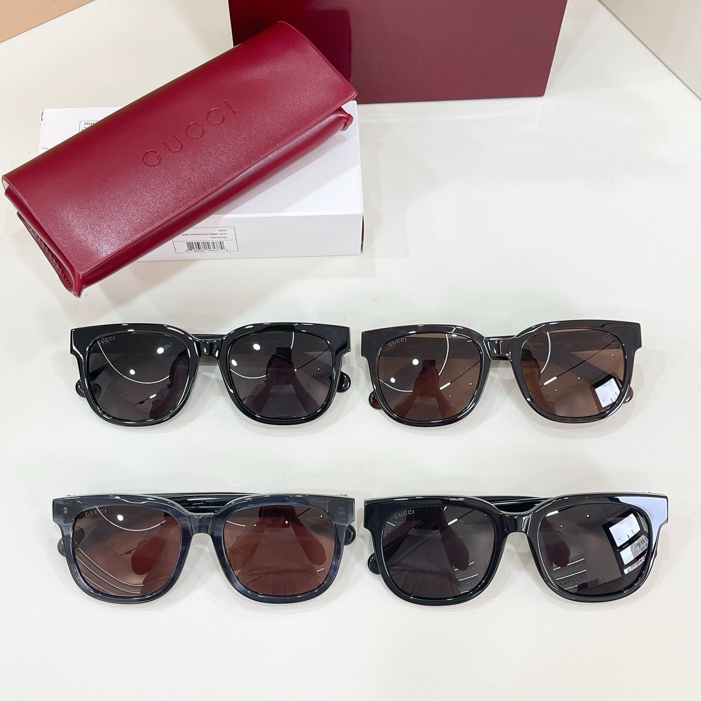 Gucci sunglasses assortment with red case and six pairs of sunglasses