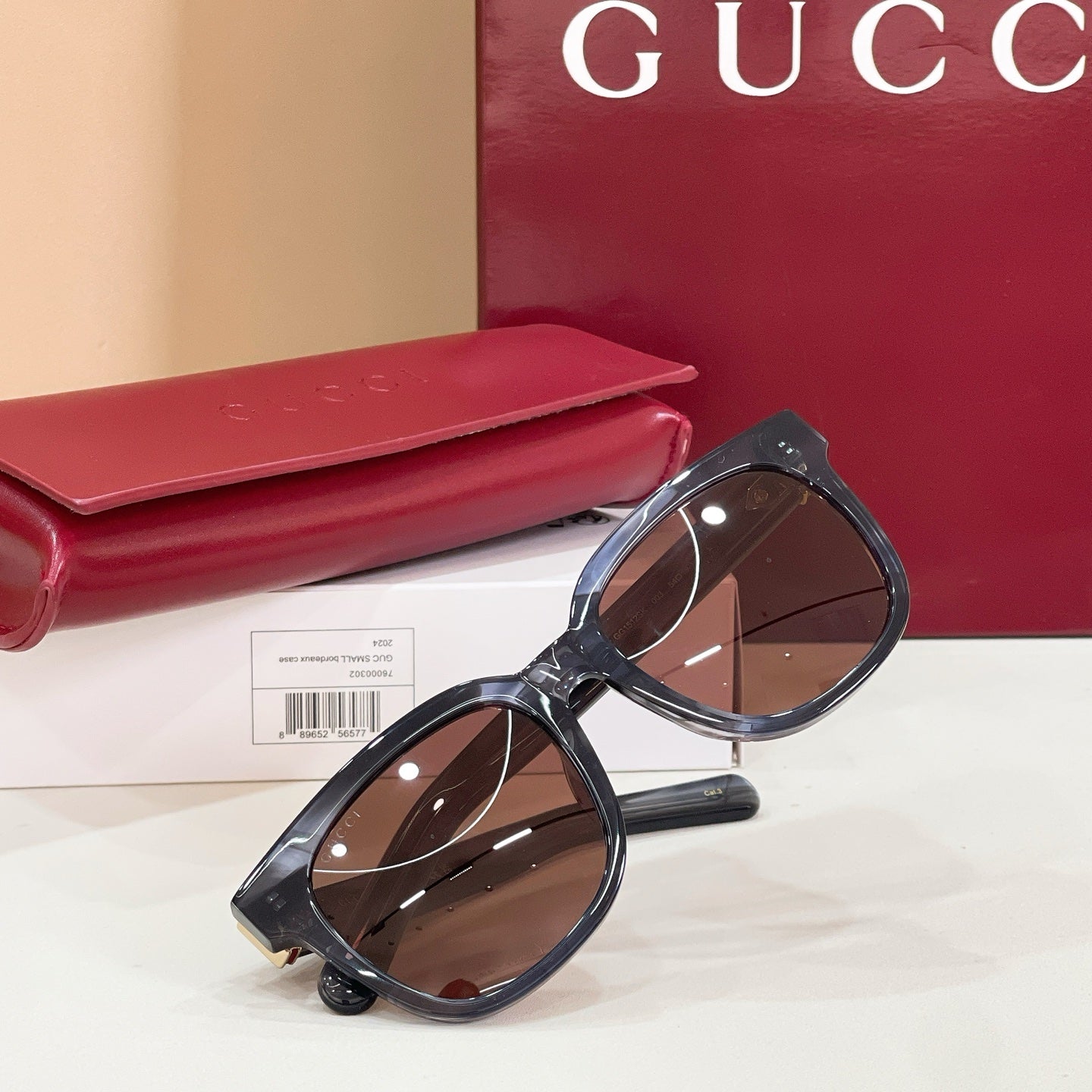 Gucci cat-eye sunglasses with black frames and brown lenses