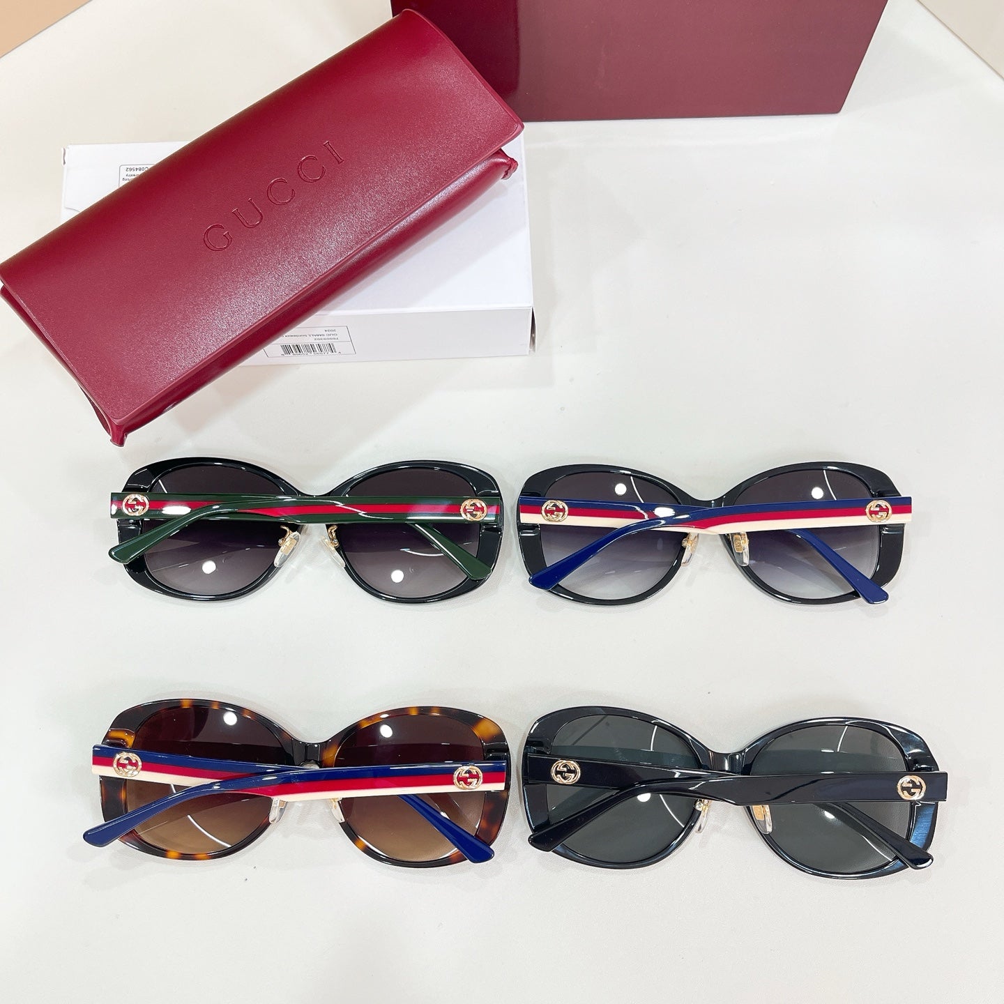Two pairs of sunglasses with striped temples in black and tortoiseshell