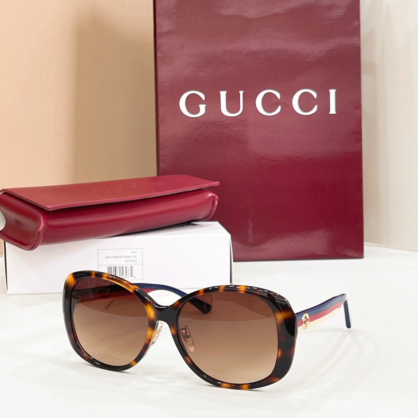 Tortoiseshell round sunglasses with tinted lenses and striped temple accents