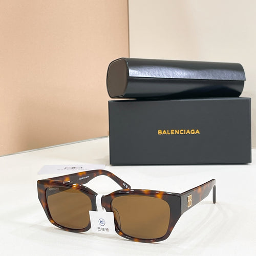 Tortoiseshell sunglasses with amber lenses and angular square frames.