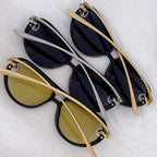 Three sunglasses with cat-eye frames: black with navy lenses, gold-tone, and silver-tone