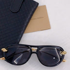 Black sunglasses with dark lenses and silver-tone accents, cat-eye frame