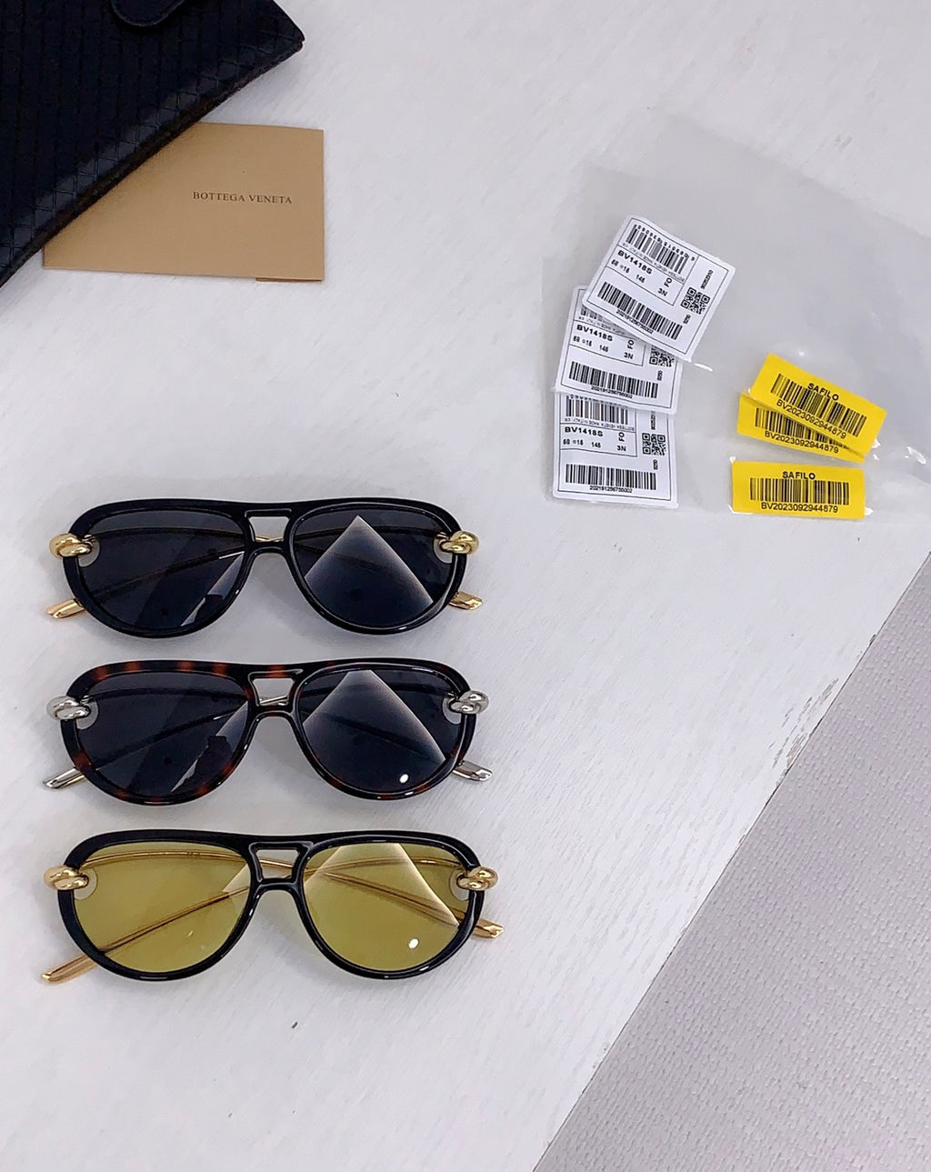 Set of three cat-eye sunglasses with dark lenses in black, tortoiseshell, and olive frames