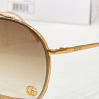 Gold Gucci sunglasses temple with engraved logo